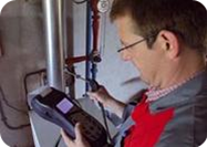 Technician testing a heating system for combustion safety