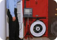 Blower door fan in a doorway for an air leakage test