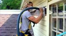 Insulation installer working on an exterior wall